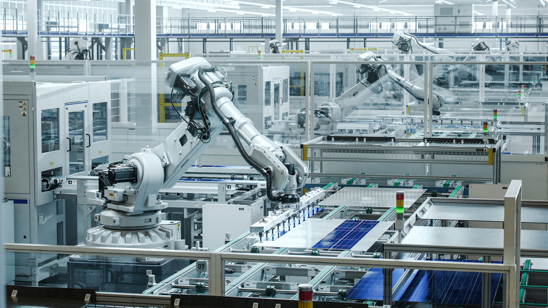 White Industrial Robot Arm at Production Line at Modern Bright Factory. Solar Panels are being Assembled on Conveyor. Automated Manufacturing Facility